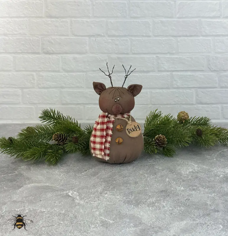 Brown Rudy baby reindeer Christmas figure with twig antlers, plaid scarf, bells, and Rudy tag